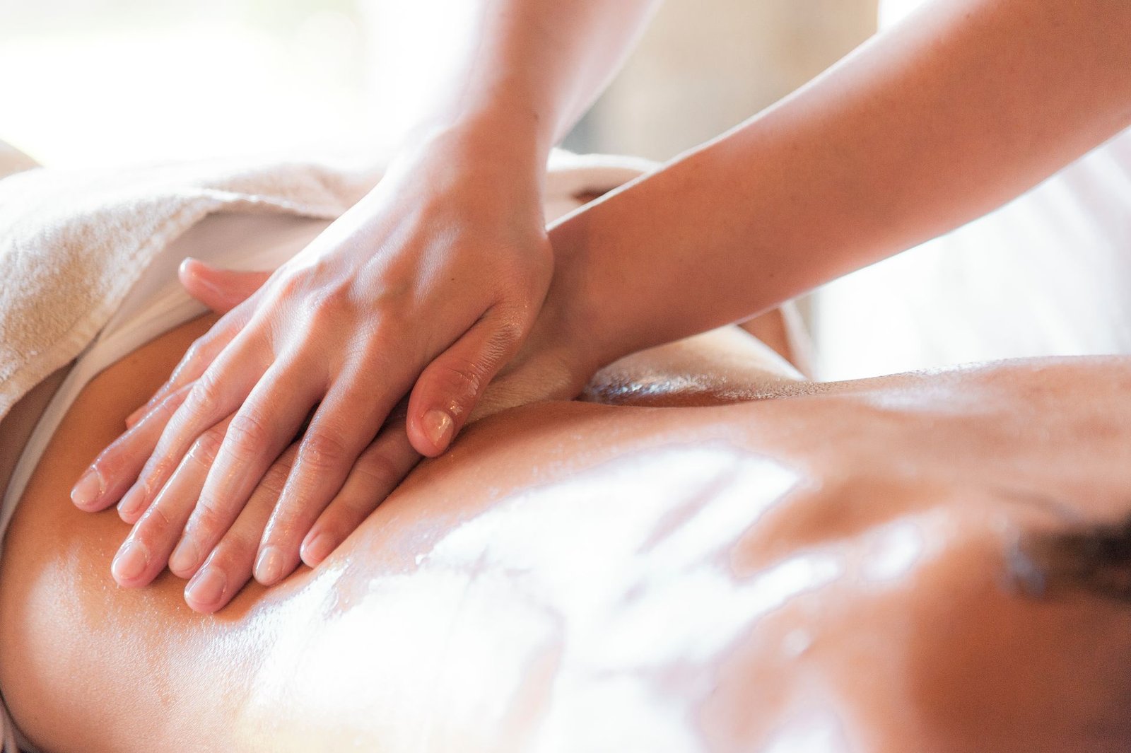 Therapist applying a soothing body care massage treatment