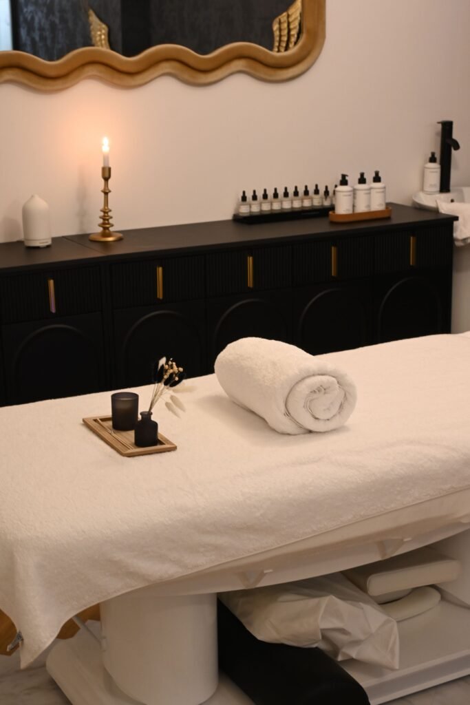 A warm, low-lit treatment room at Buddha Spa in Jaipur, with fresh linen laid out on the massage table