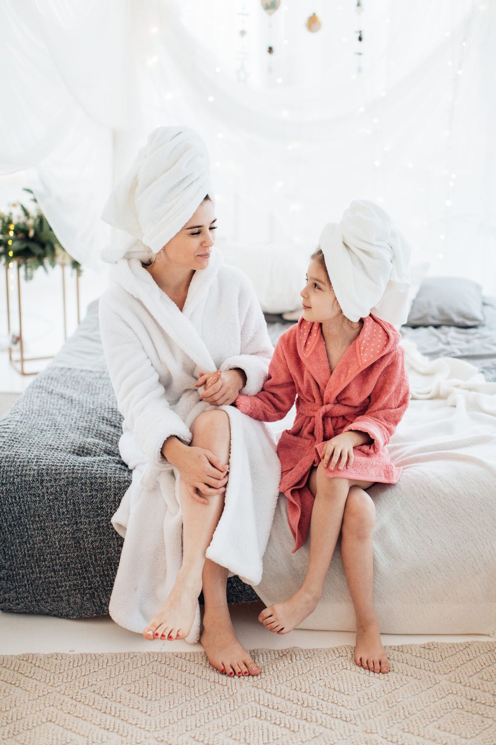 Mother and daughter relaxing together in robes during a family wellness day